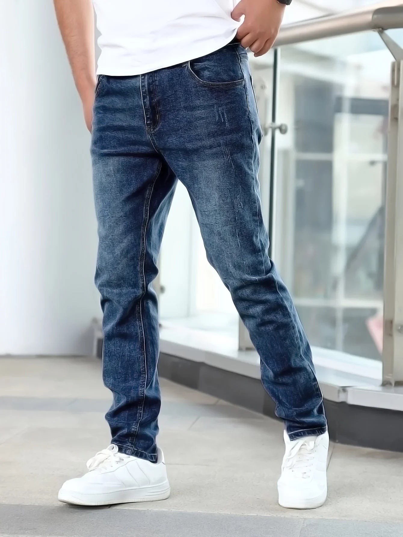 Dark blue casual stretch jeans with straight-leg fit and subtle wash pattern