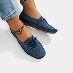 Navy suede lace-up loafers with stitched edges and low profile rubber sole.