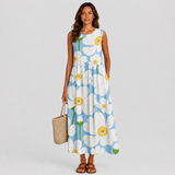 Sleeveless summer dress with white base and blue flower circle print, green accents