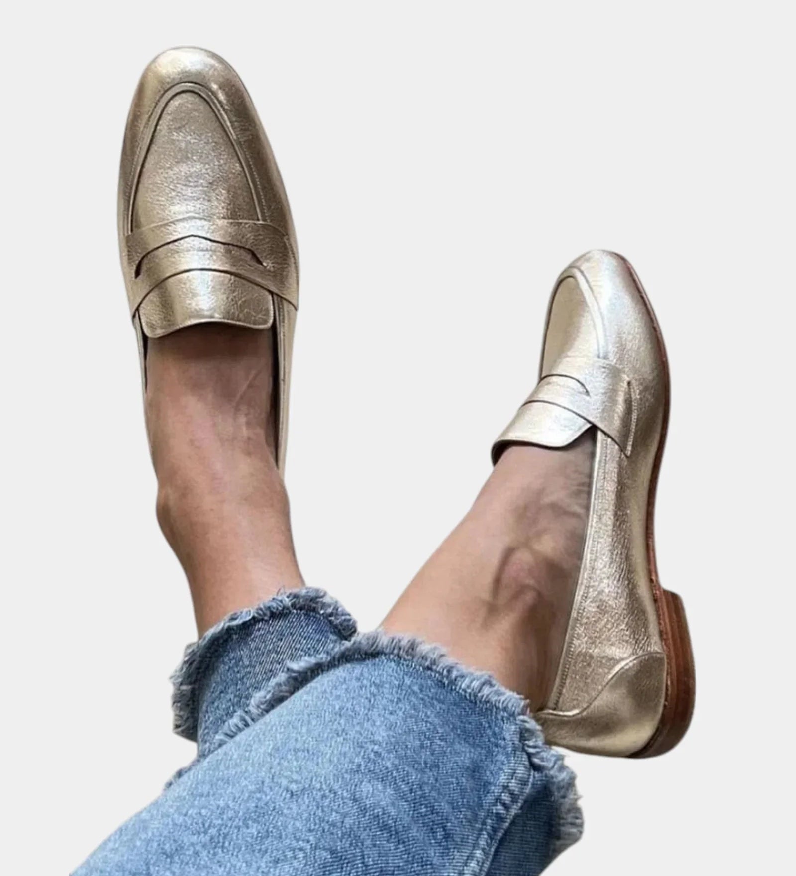 Shiny gold slip-on loafers with strap across the top