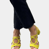 Yellow square-toe sandals with rounded cutout straps and small back heel