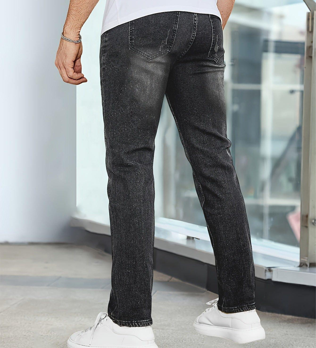 Black casual stretch jeans, back view with stitched pockets and straight-leg fit