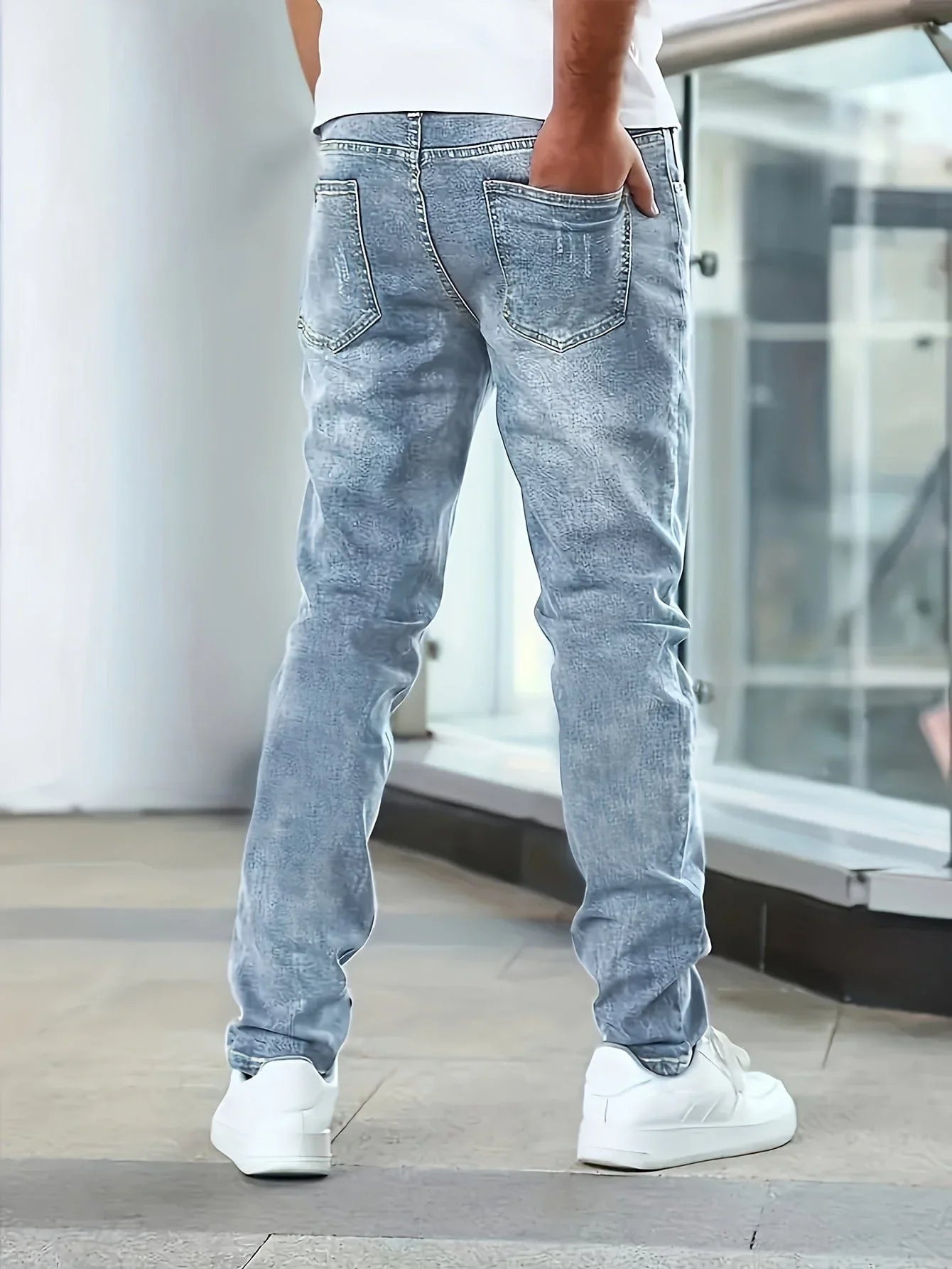 Blue casual stretch jeans, rear view with two back pockets and straight-leg cut