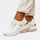 White orthopedic lace-up sneaker with perforated toe and gold trim wedge sole