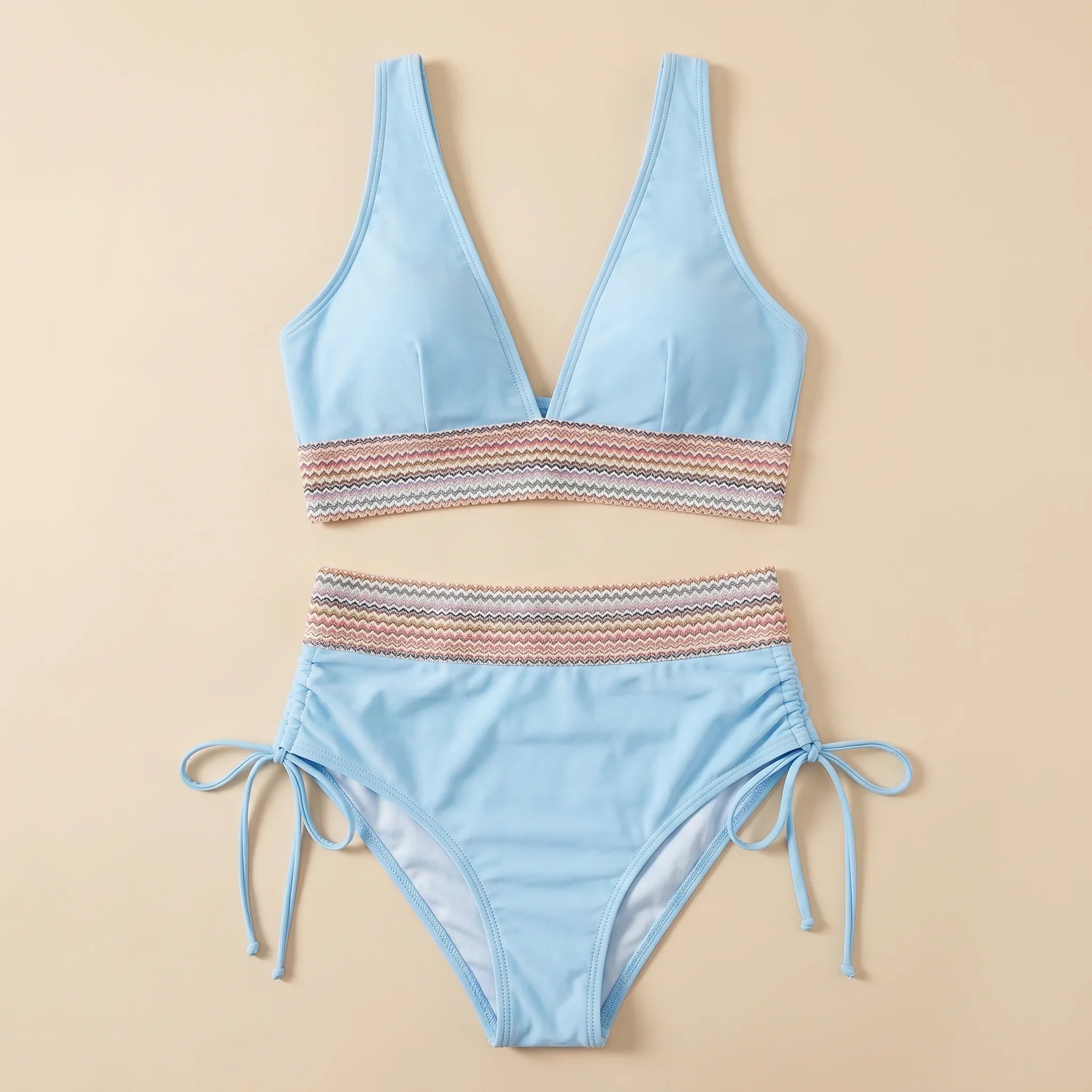 Light blue two-piece swimsuit: V-neck top with striped band, tie-side bikini bottoms