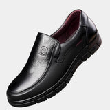Black leather slip-on non-slip shoes with cushioned lining and chunky tread sole