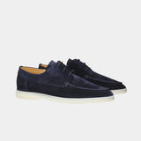Navy blue lace-up suede loafers with low-profile white rubber sole