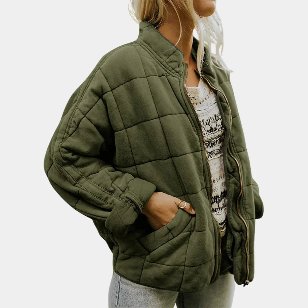 Green oversized quilted jacket with front zipper, stand collar, and patch pockets.