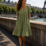 Olive green textured V-neck midi dress with short sleeves and tiered skirt