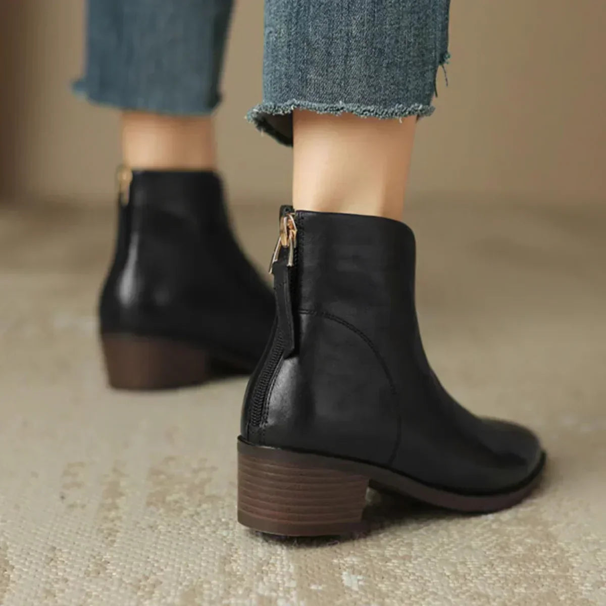 Black leather ankle boots with side zipper and low block heel