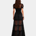 Back view of black long dress with puff sleeves and layered sheer skirt