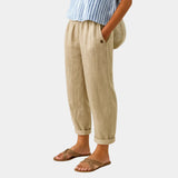 Beige linen-effect pants with elastic waist, button detail, and cuffed ankle hems