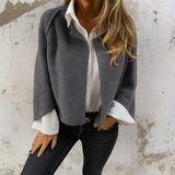 Gray short jacket with snap button front and rounded collar, long sleeves