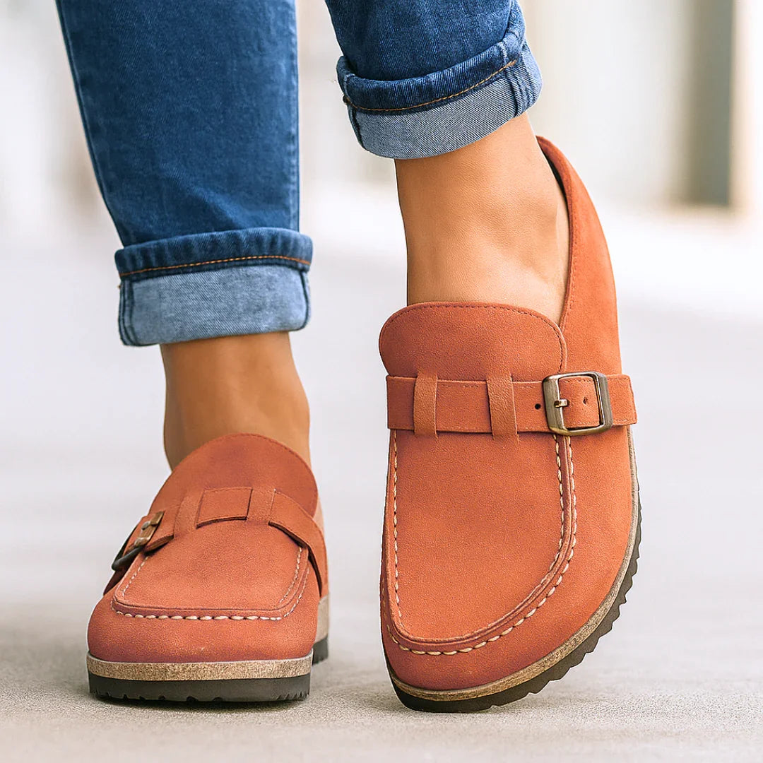 Orange orthopedic slip-on loafers with buckle strap and stitched moc toe