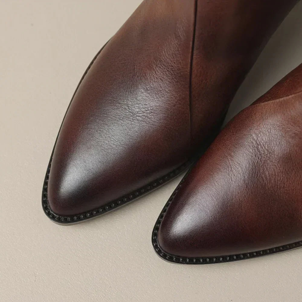 Brown leather ankle boot toe and seam detail with rounded stitching edge