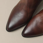 Brown leather ankle boot toe and seam detail with rounded stitching edge