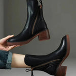 Pair of black ankle boots with side zipper and tassel, stacked block heel