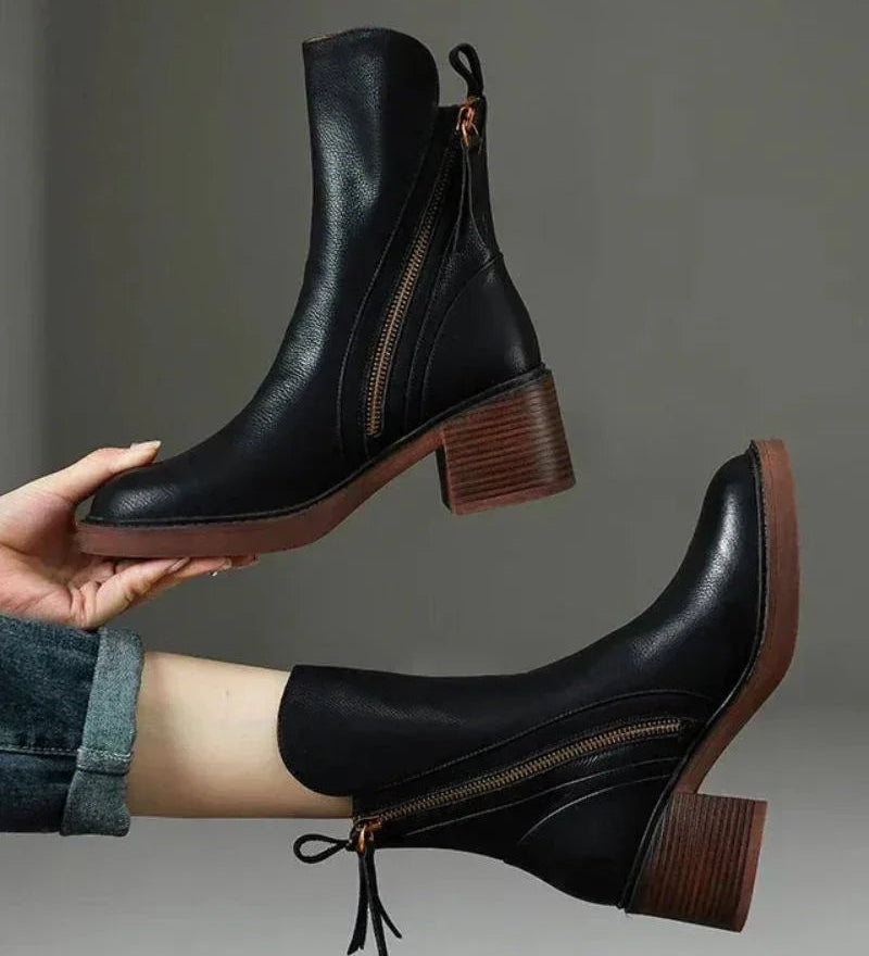 Pair of black ankle boots with side zipper and tassel, stacked block heel