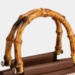 Knitted style bag with bamboo top handle and brown faux-leather front