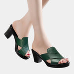 Green orthopedic slide sandals with wide cross straps and chunky block heel