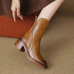 Brown leather ankle boots, pointed toe, side zip, and tassel pull tab
