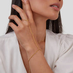 Gold chain hand bracelet worn on hand with slim linked design