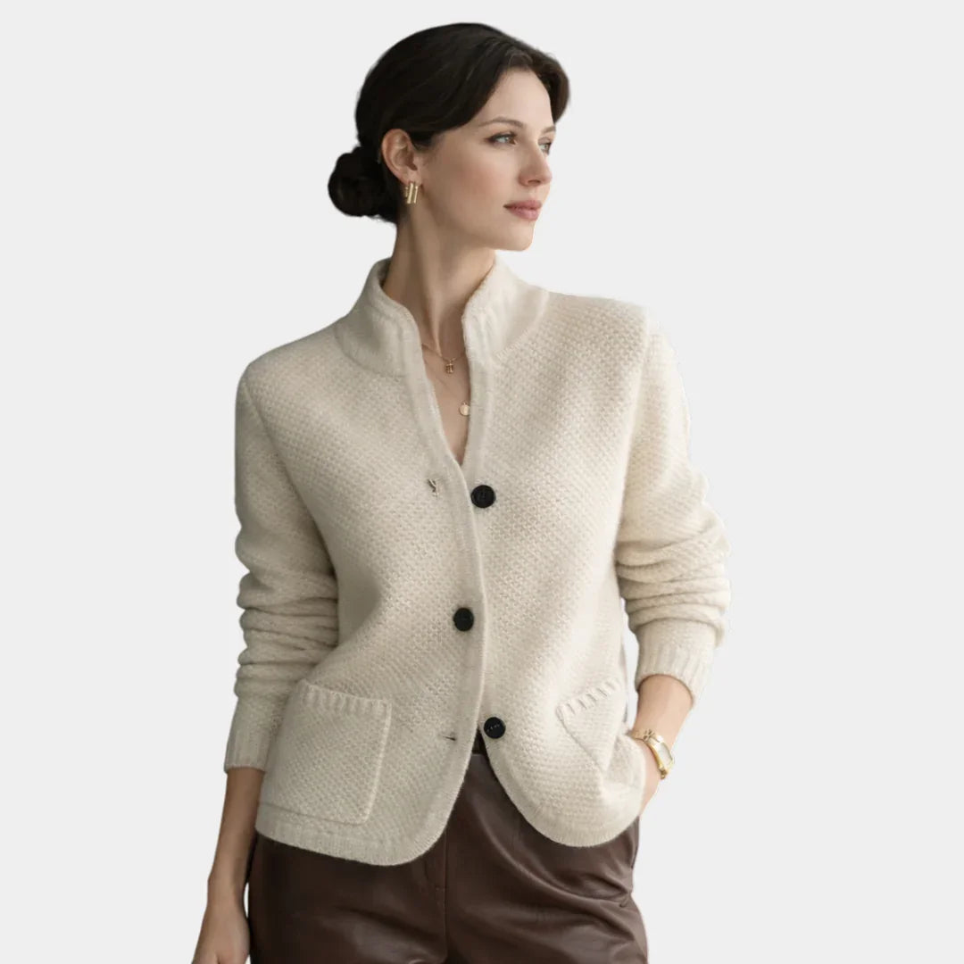 Cream knit cardigan with button front, stand collar, and two patch pockets