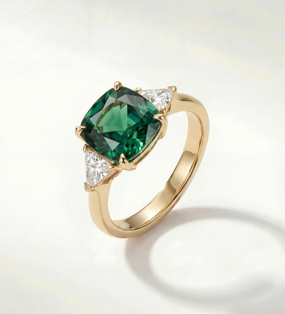 Gold ring with large green oval gemstone and small clear accents