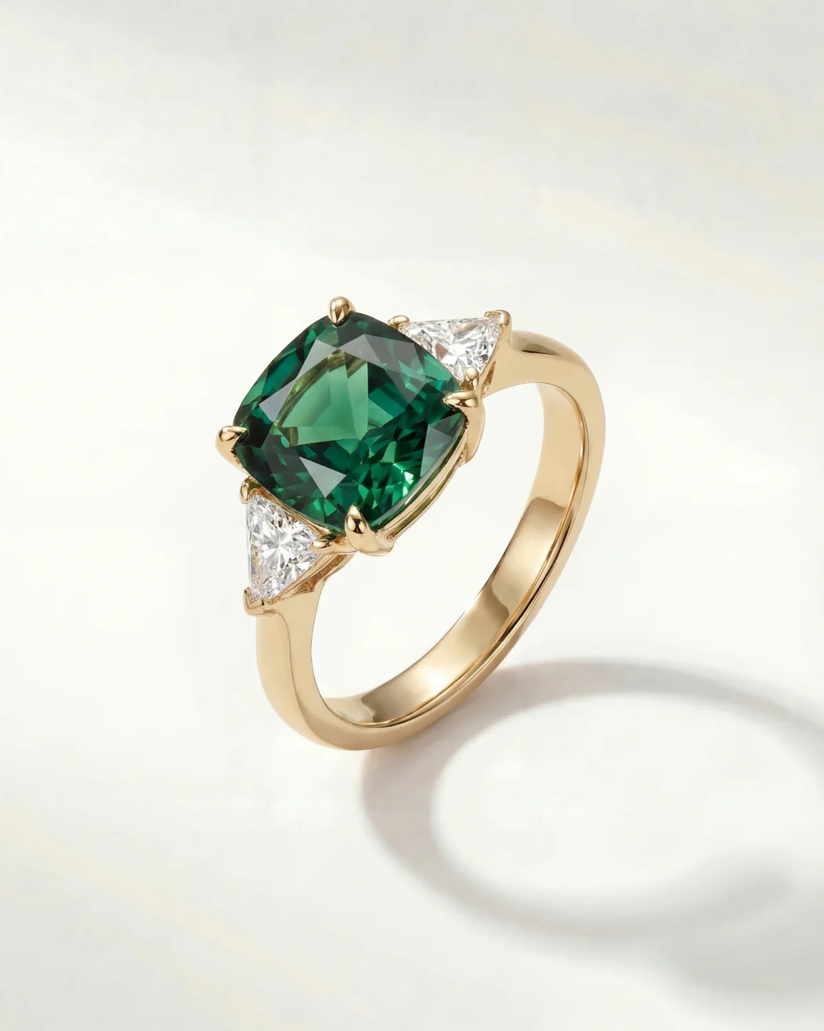 Gold ring with large green oval gemstone and small clear accents