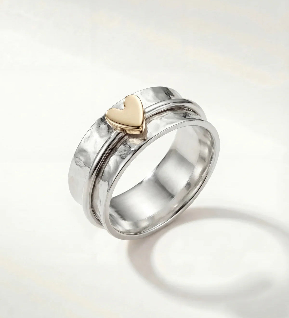 Silver heart ring with gold-tone heart centerpiece, wide band and open-backed design