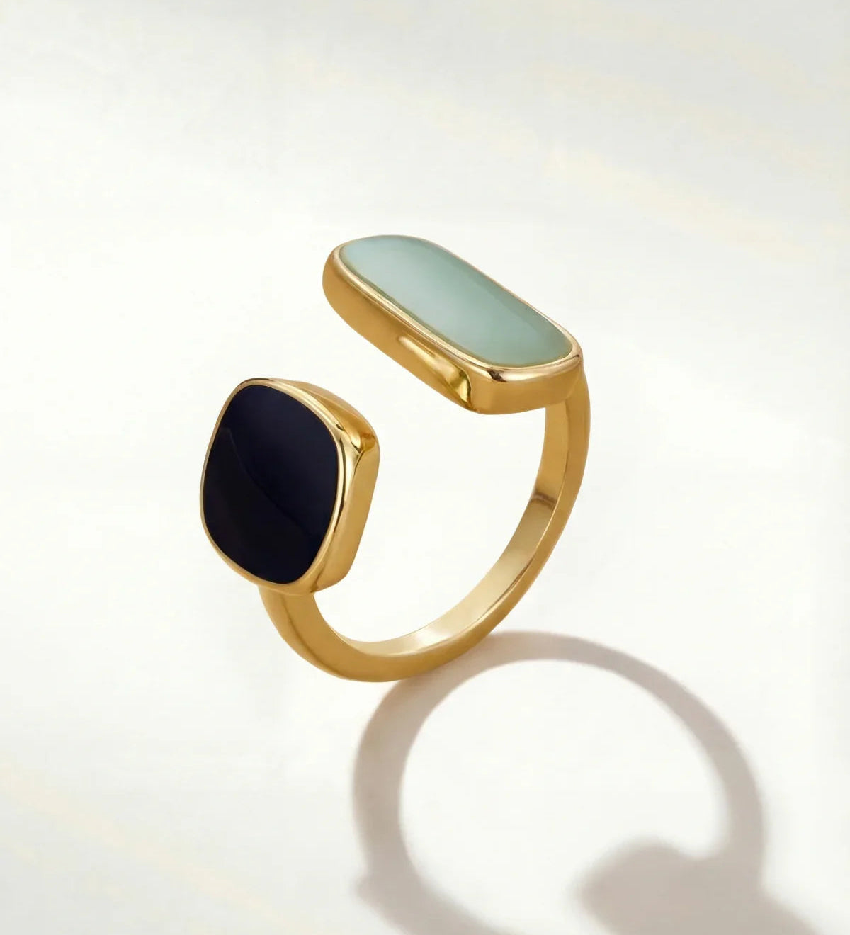 Gold-tone adjustable ring with oval mint and round dark cabochon stones