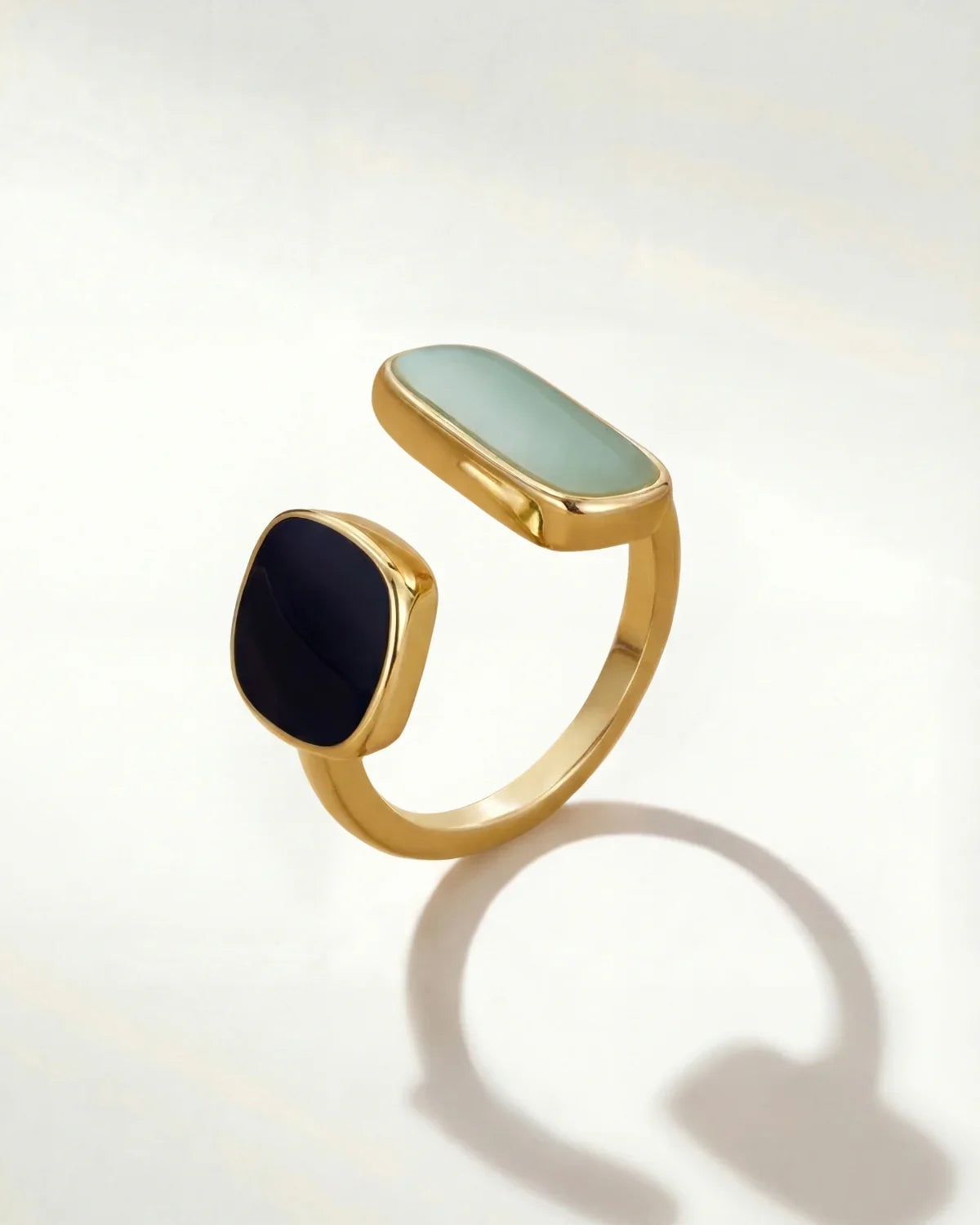 Gold-tone adjustable ring with oval mint and round dark cabochon stones