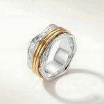 Stacked silver ring with textured band and two slim gold-tone bands