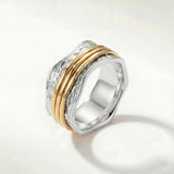 Stacked silver ring with textured band and two slim gold-tone bands