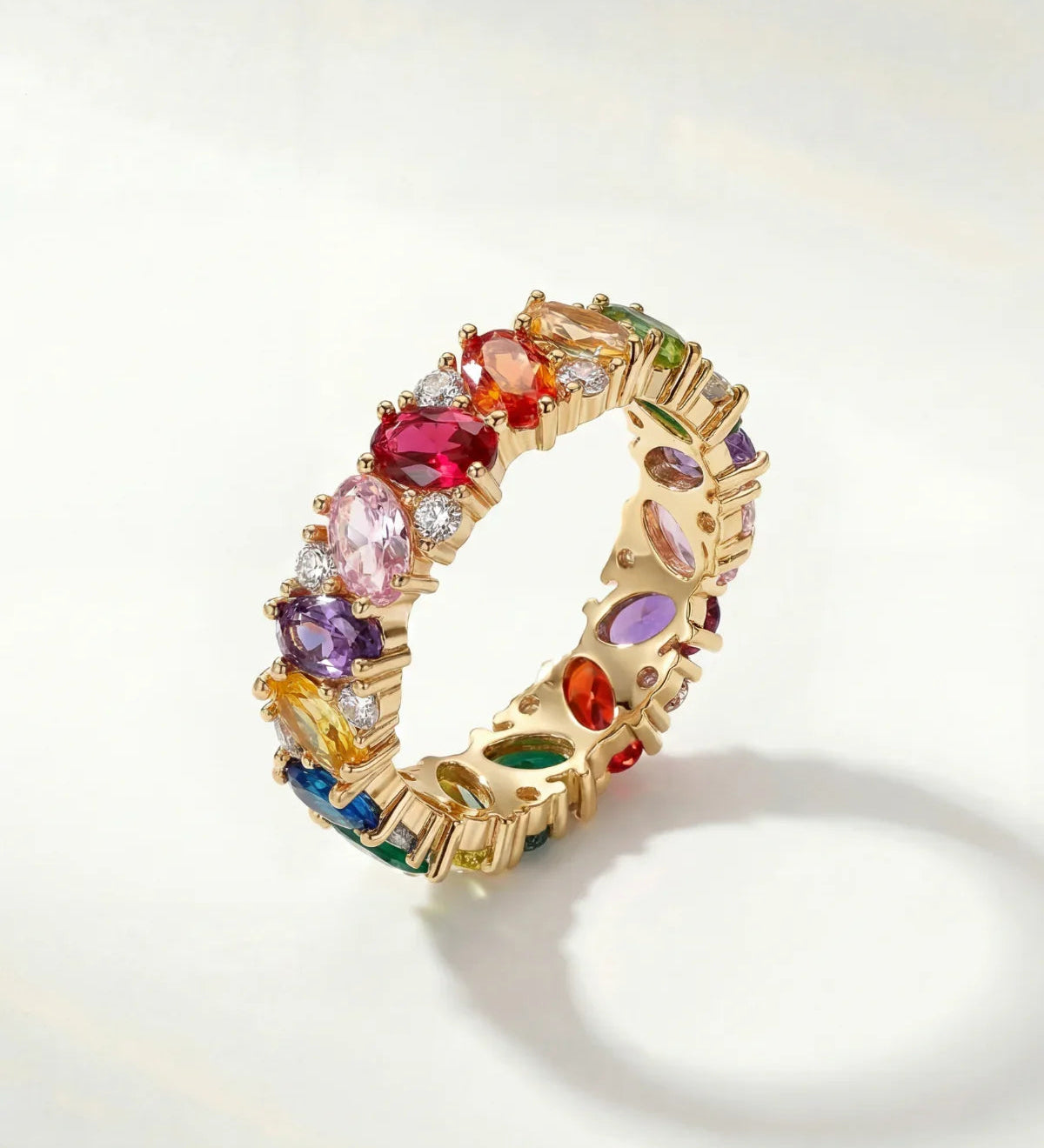 Gold ring with multicolored gemstone stones, rainbow band detail