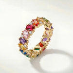 Gold ring with multicolored gemstone stones, rainbow band detail
