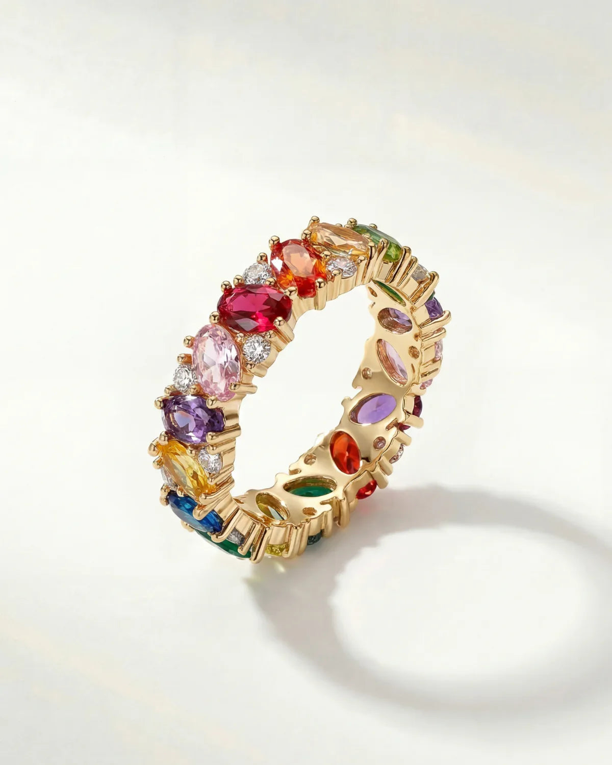 Gold ring with multicolored gemstone stones, rainbow band detail