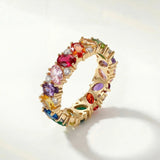 Gold ring with multicolored gemstone stones, rainbow band detail