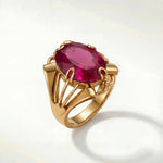 Livia sapphire ring with gold band and oval magenta gemstone in prong setting