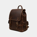 Dark brown leather backpack front view with flap, buckles, and side pockets