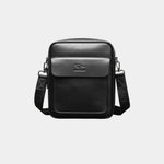 Black leather shoulder bag with flap, top handle, and adjustable crossbody strap