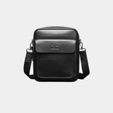 Black leather shoulder bag with flap, top handle, and adjustable crossbody strap