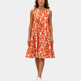 Orange sleeveless V-neck dress with bold leaf print and tiered ruffle hem
