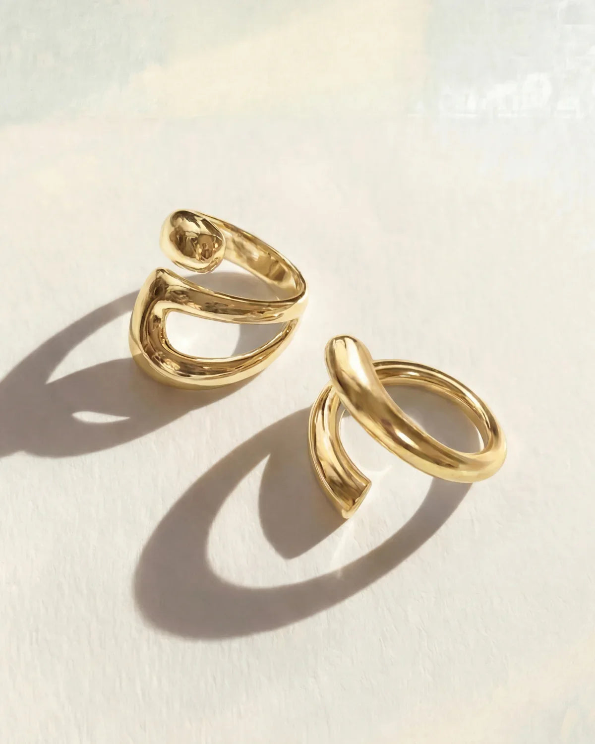 Gold ring set with two stacked open oval bands, adjustable fit