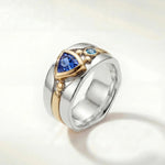 Silver statement ring with blue oval stone and gold-toned details on band