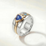 Silver statement ring with blue oval stone and gold-toned details on band