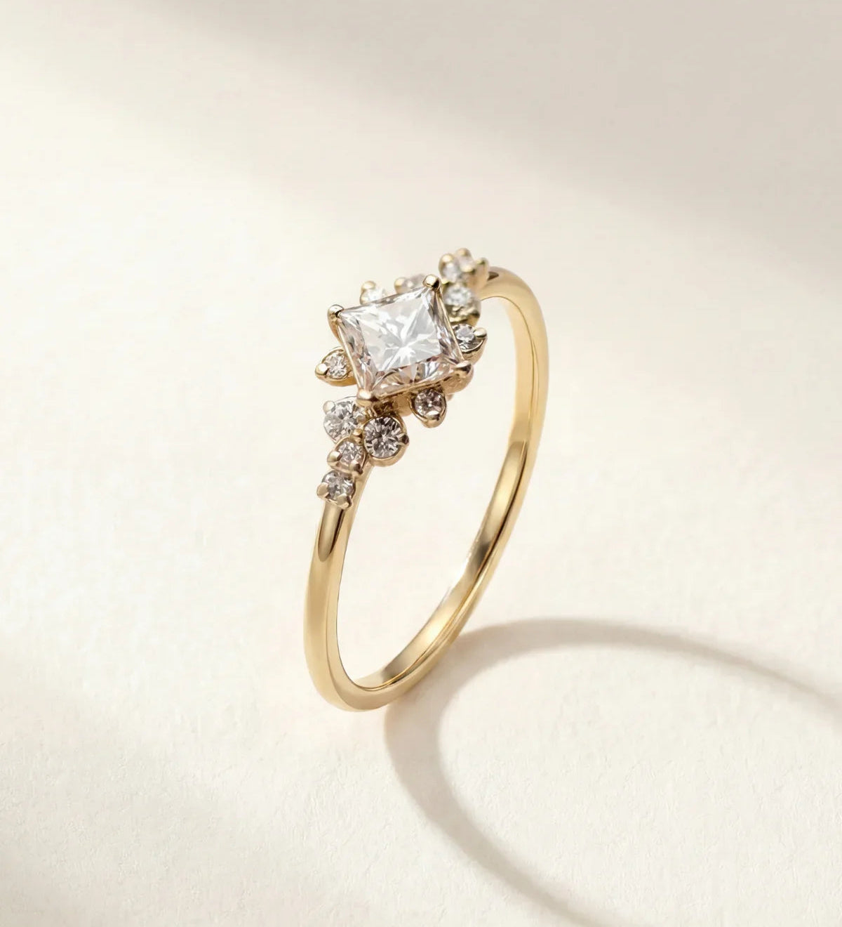 Gold ring with clear cluster stone and small side stones on a slim band