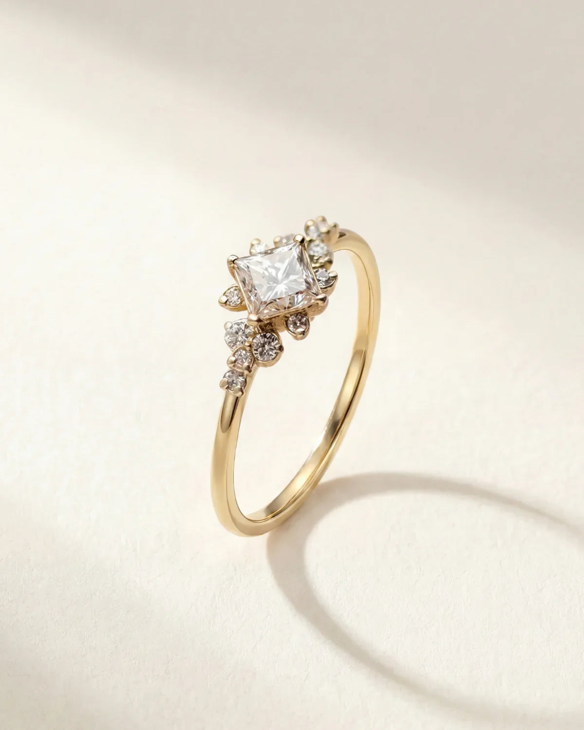Gold ring with clear cluster stone and small side stones on a slim band