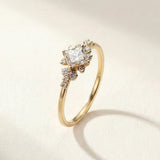 Gold ring with clear cluster stone and small side stones on a slim band