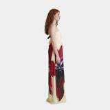 Side-view strapless maxi dress with red, cream, and black abstract print